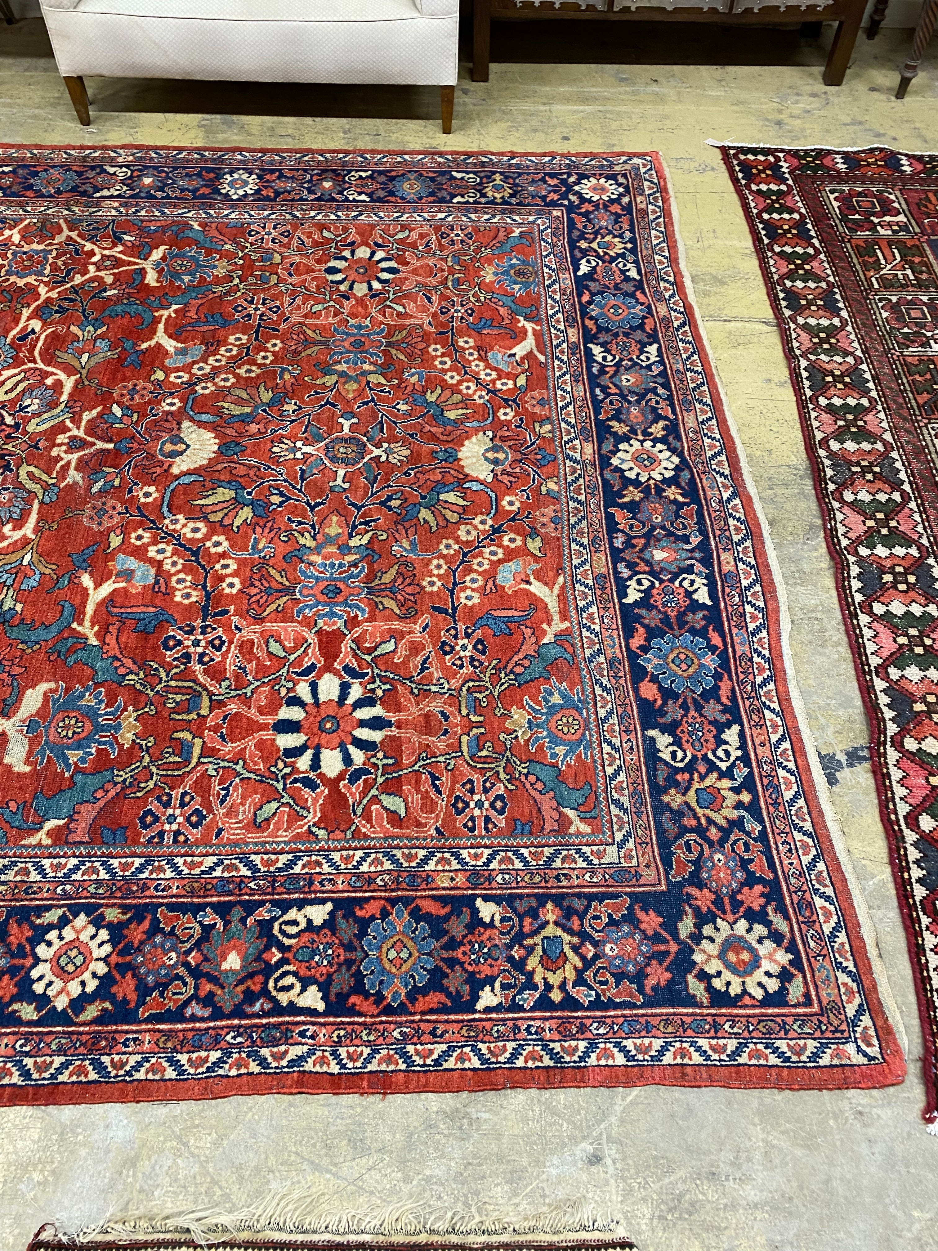 A Heriz brick red ground carpet, 364 x 280cm